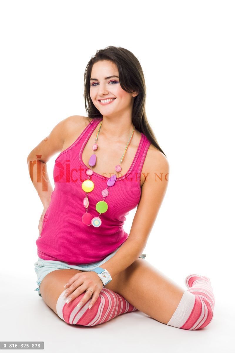 Woman in pink with big smile sit on the floor