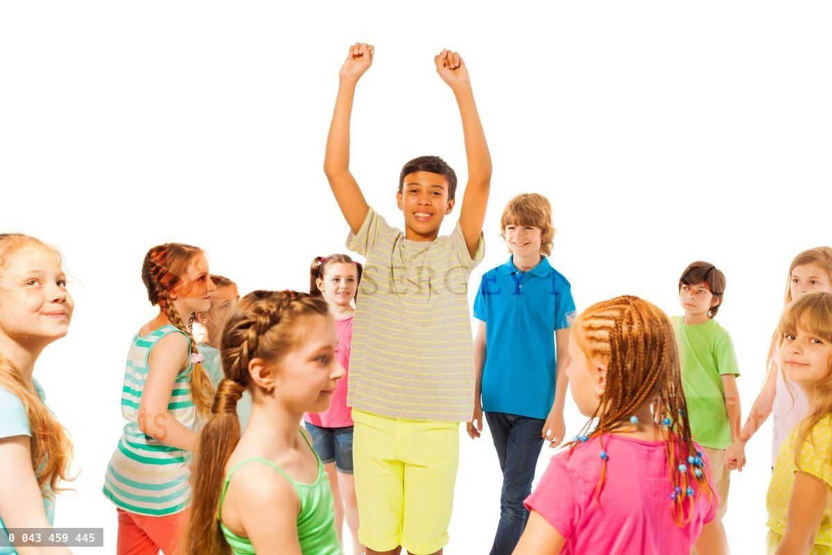 Boy stand in the crowd with lifted hands