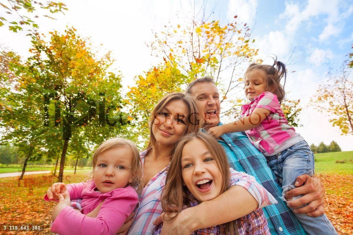Happy family play in autumn park hug little kids