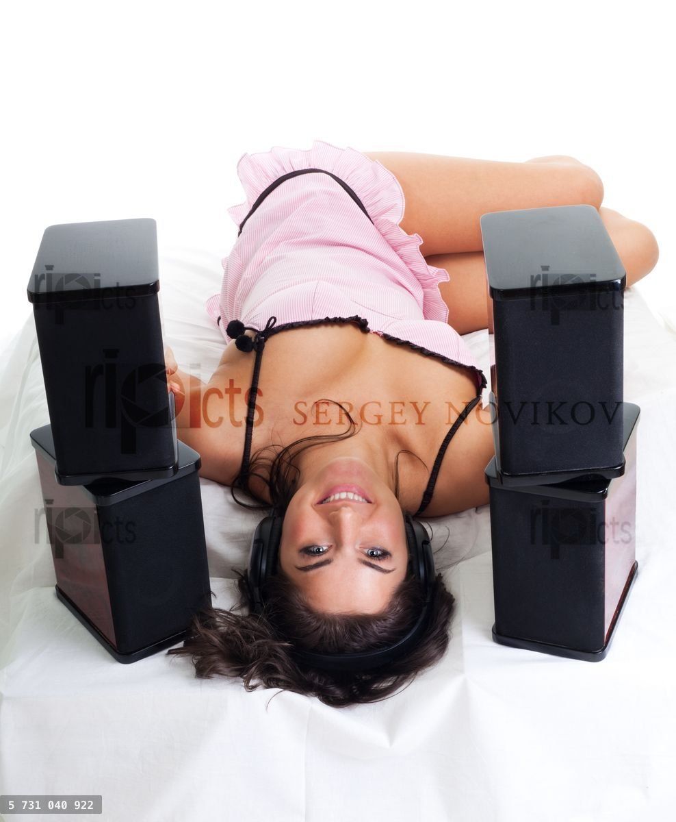 Young woman lay in bed and listen music