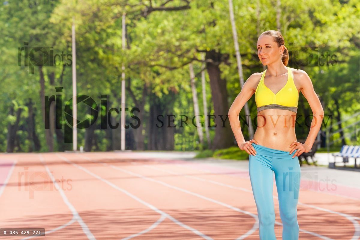 Young woman recovering after training at stadium