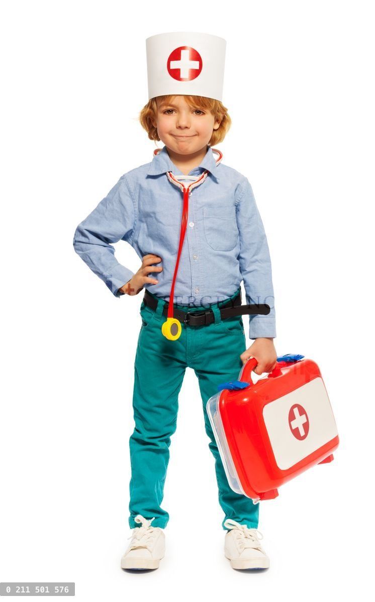 Young boy in doctors cap and with toy instruments