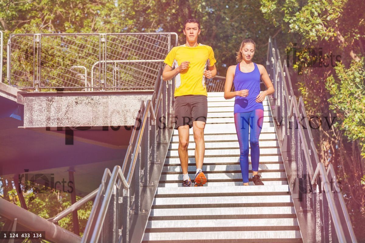Young athletes running down the steps of city park