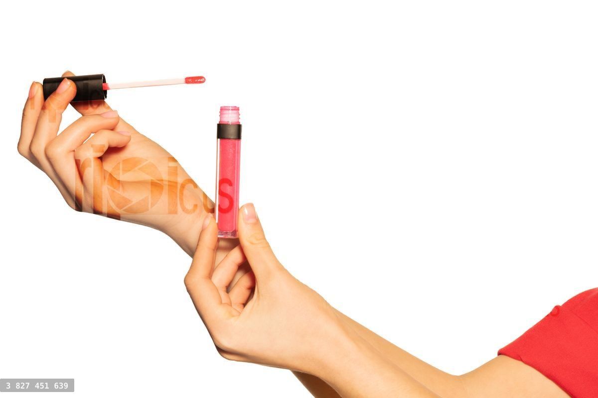 Woman's hands with liquid lipstick and applicator