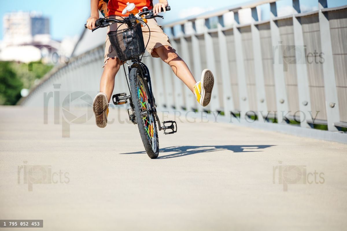 Front view of the boy ride a bicycle and have fun