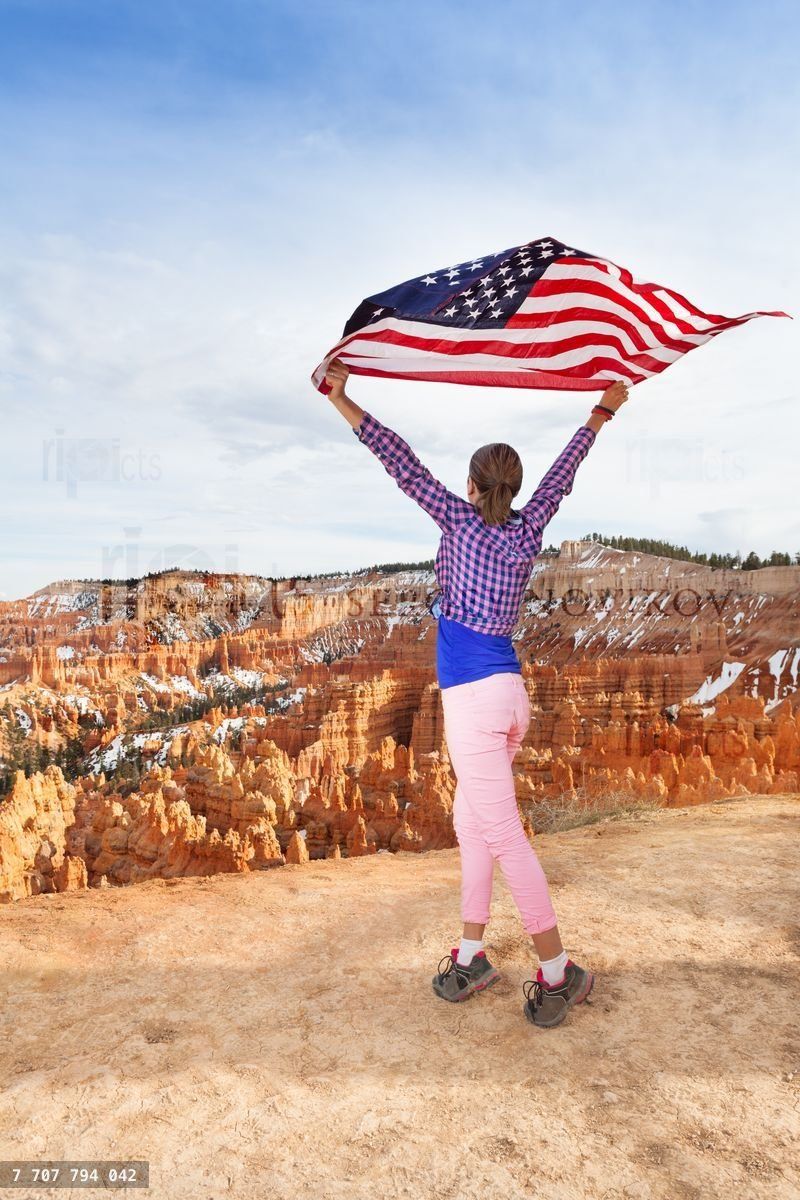 Woman holds US flag, Bryce Canyon National Park