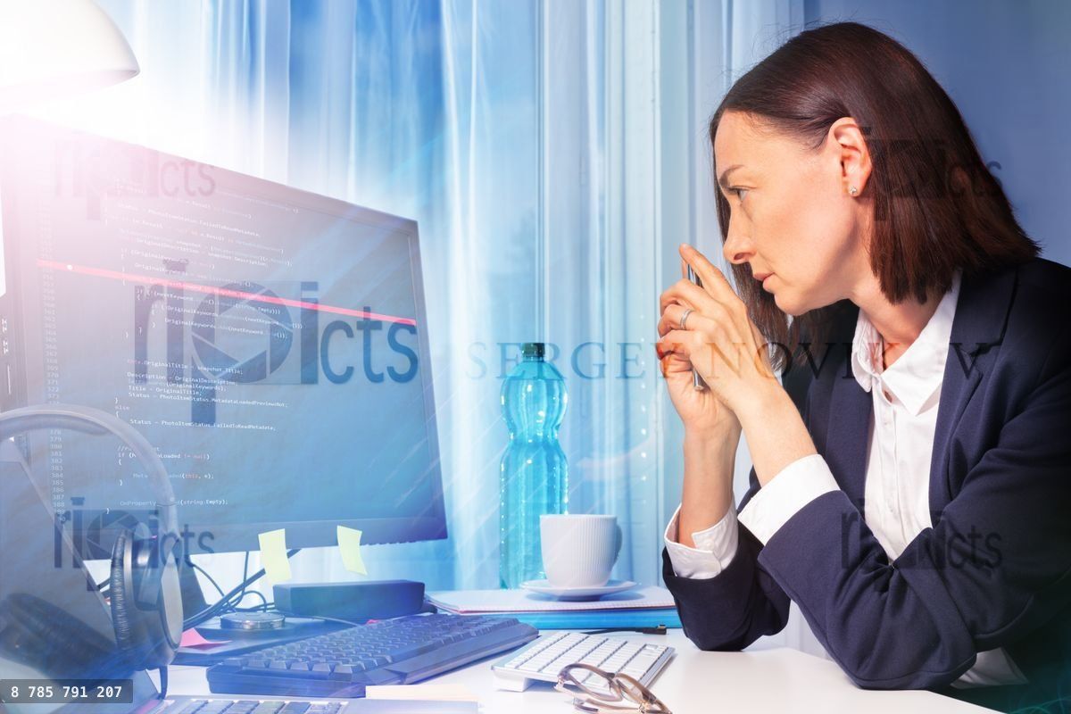 Woman looking at screen of computer in the office