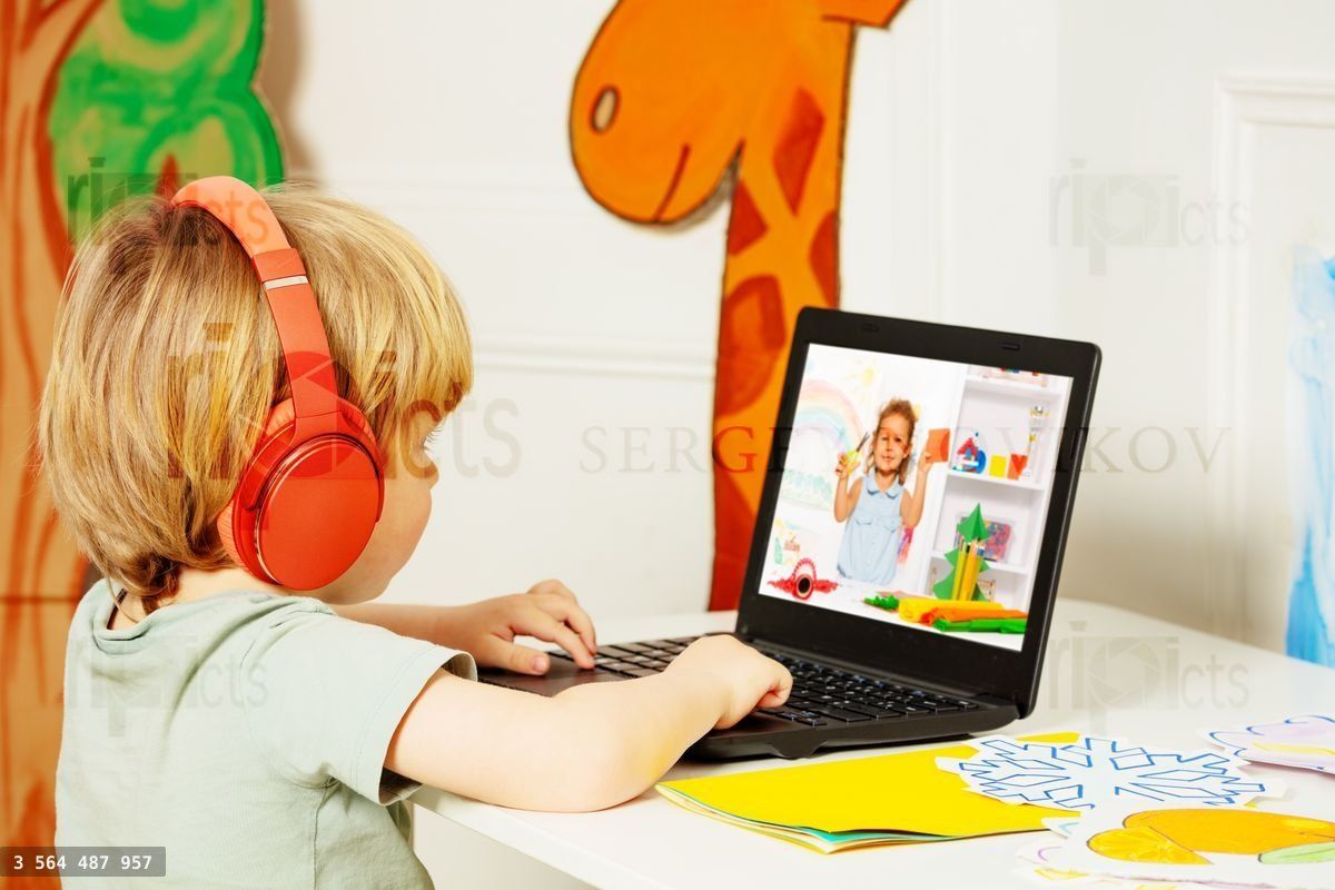 Blond boy watch education videos over internet on laptop