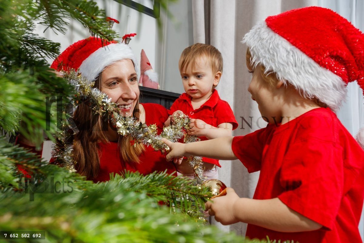 Family bonding time while decorating a festive Christmas tree