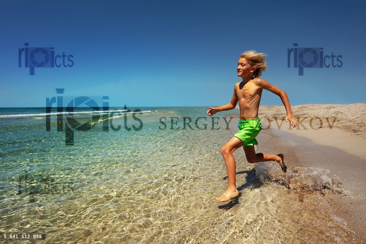 Young boy preparing to jump into the sea