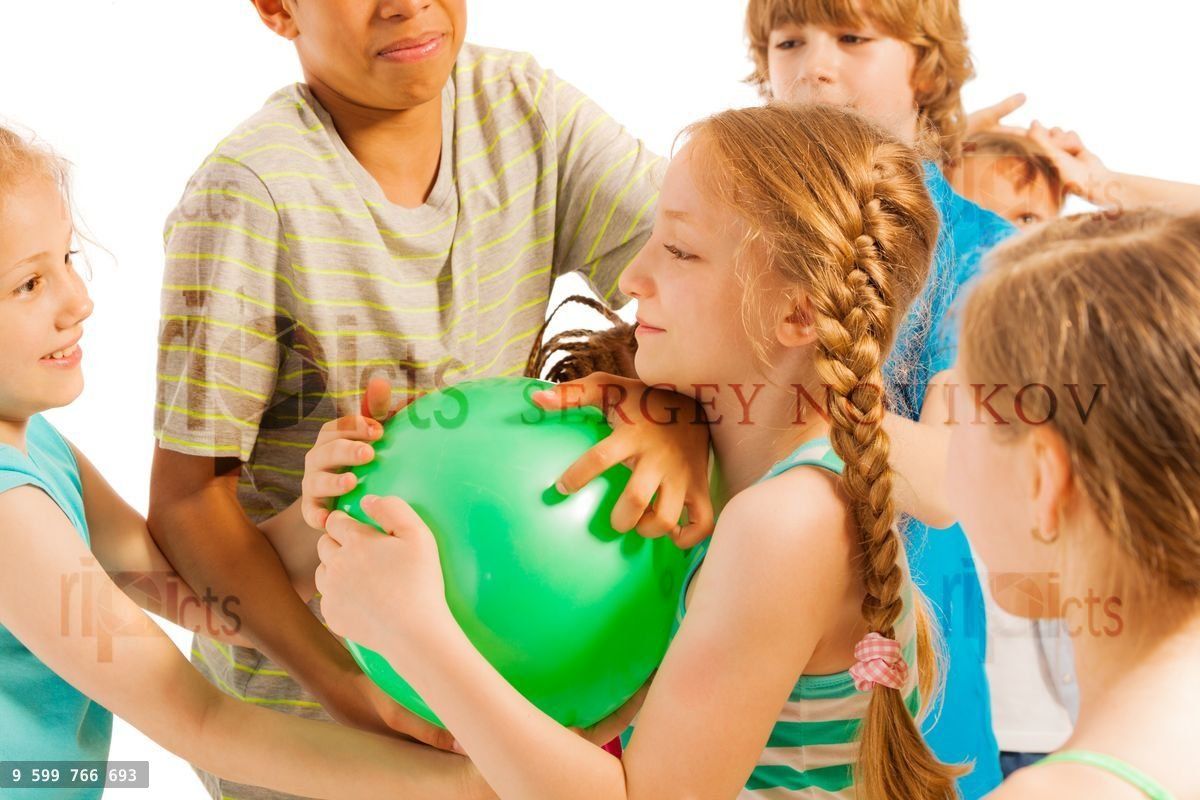 Group of kids fighting over the ball