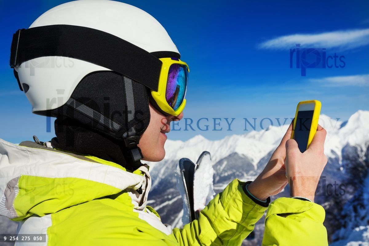 Woman in ski mask and helmet use cell phone