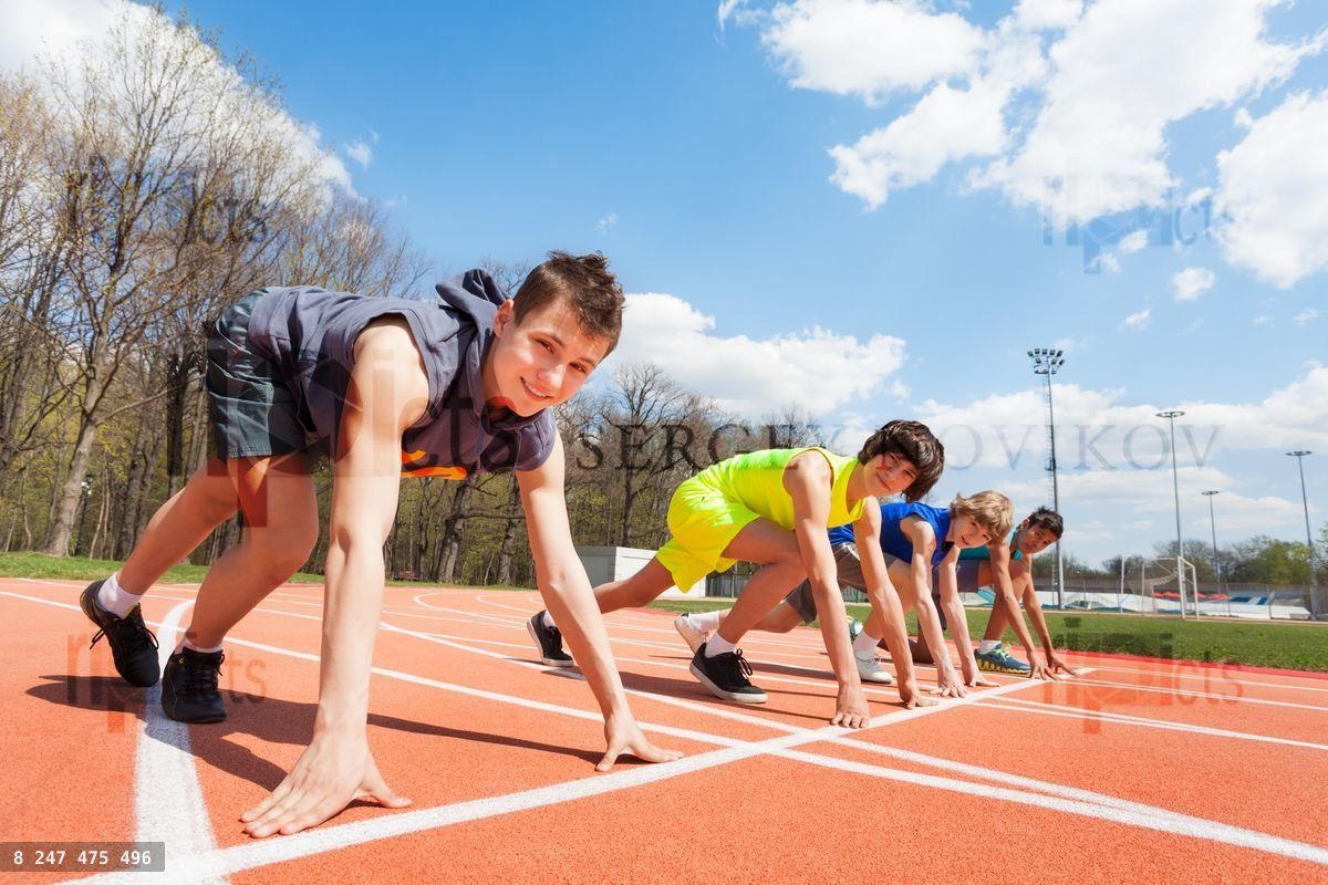 Four teenage runners lined up ready to race