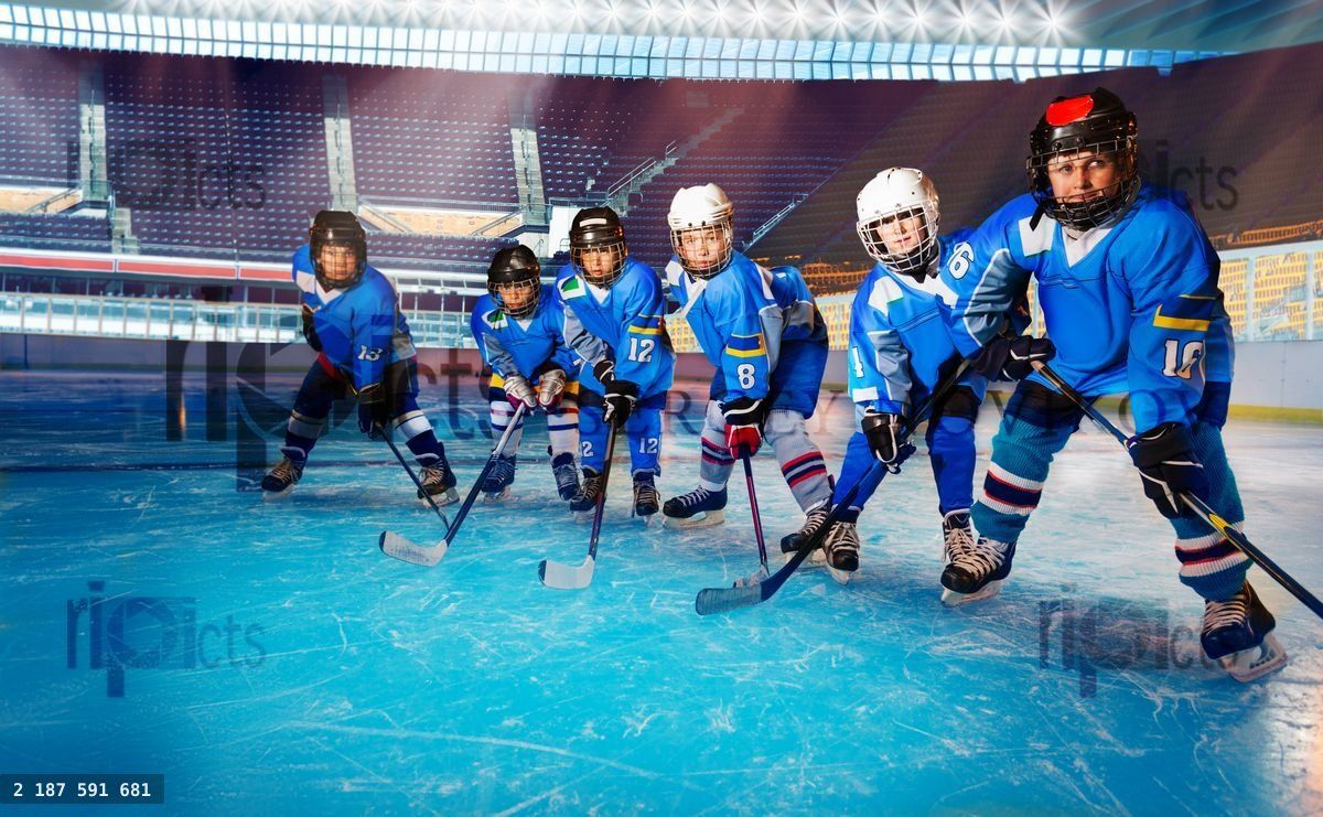 Young hockey players ready for puck on ice rink