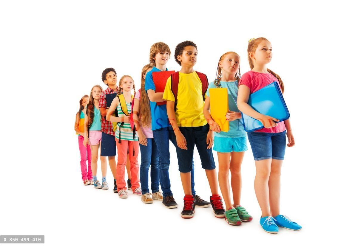 Many kids standing in line with books