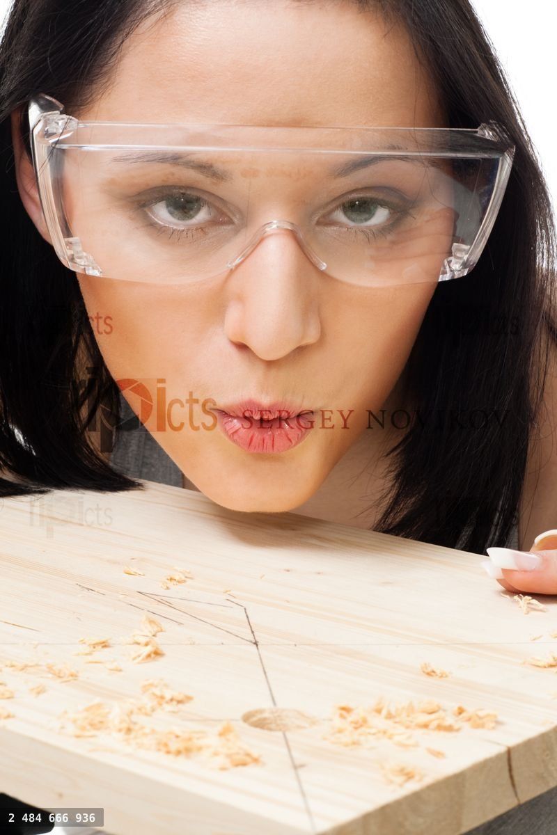 Woman carpenter blow away scobs
