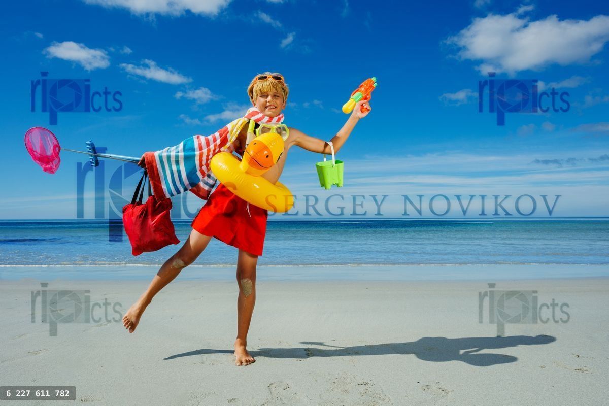 Fun relax vacation boy with many toys inflatable duck, scuba etc