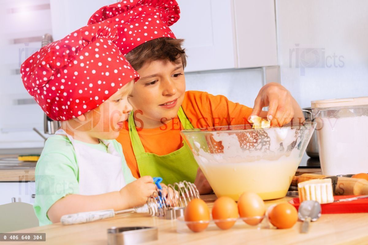 Boys add eggs and butter to mixing bowl cooking