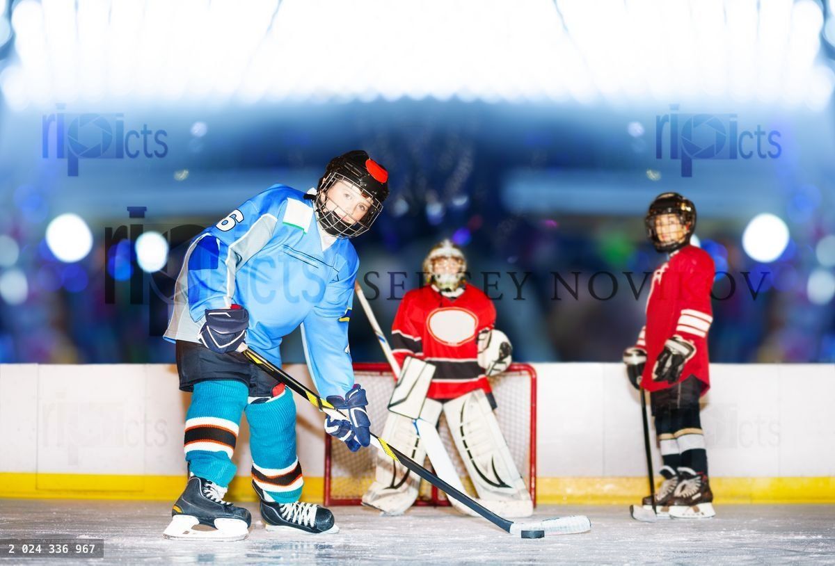 Young defenseman passing puck during hockey match
