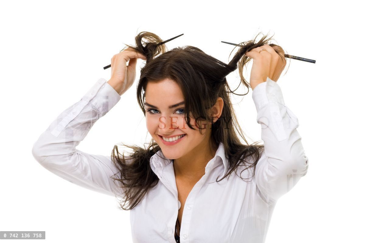woman twirl her hair with sticks