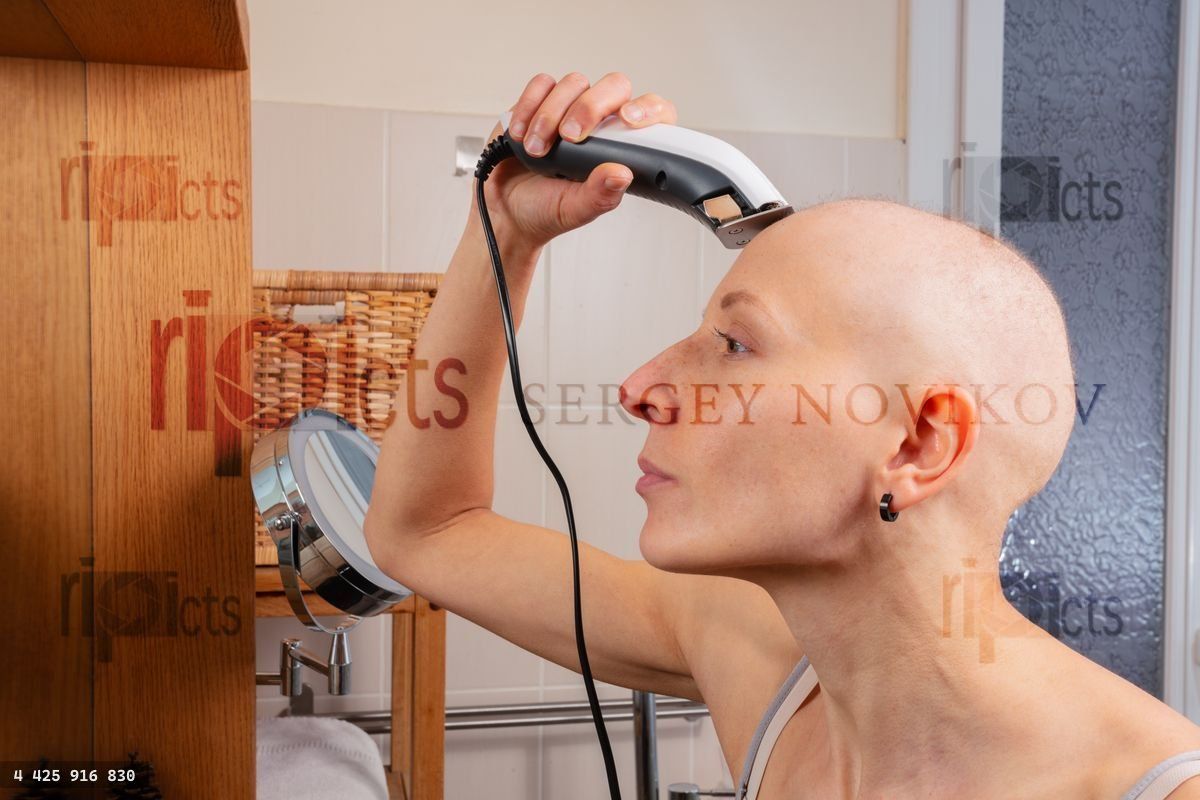 Hairless lady after cancer treatment shaves head in mirror