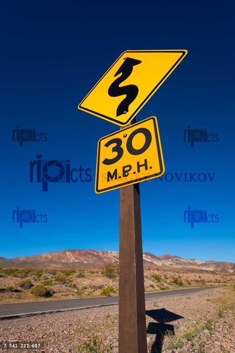 Close up of yellow road sign in desert, California
