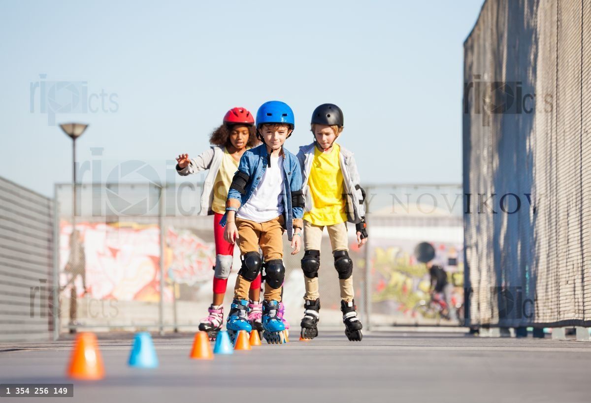 Young inline skaters exercising on slalom course