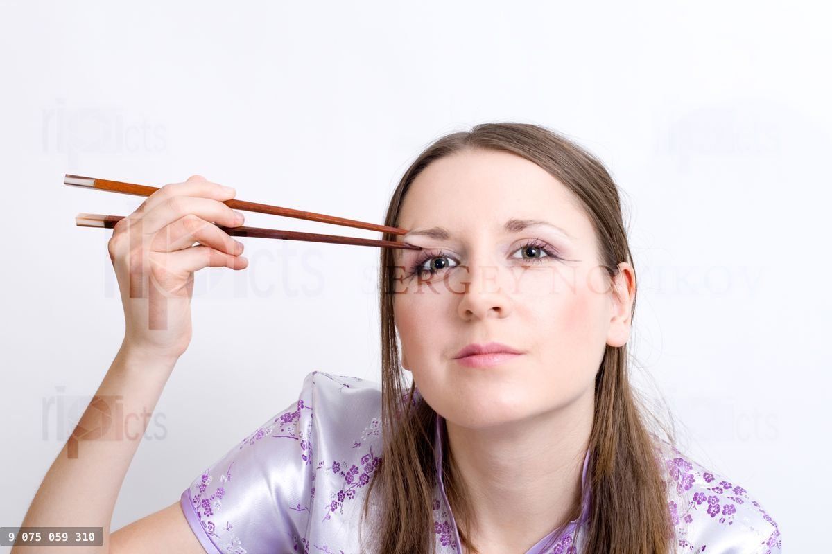 Woman with chopsticks for sushi