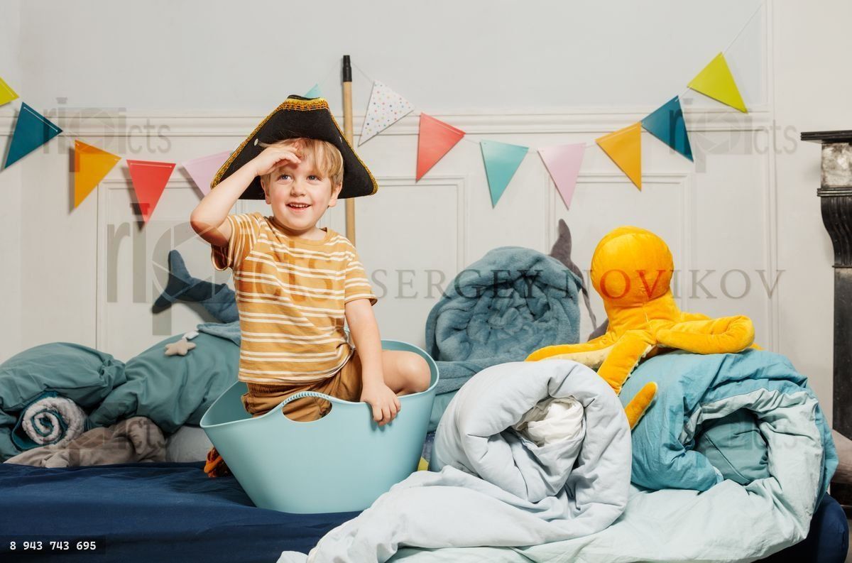 Young boy in pirate hat enjoys imaginative play with plush toys