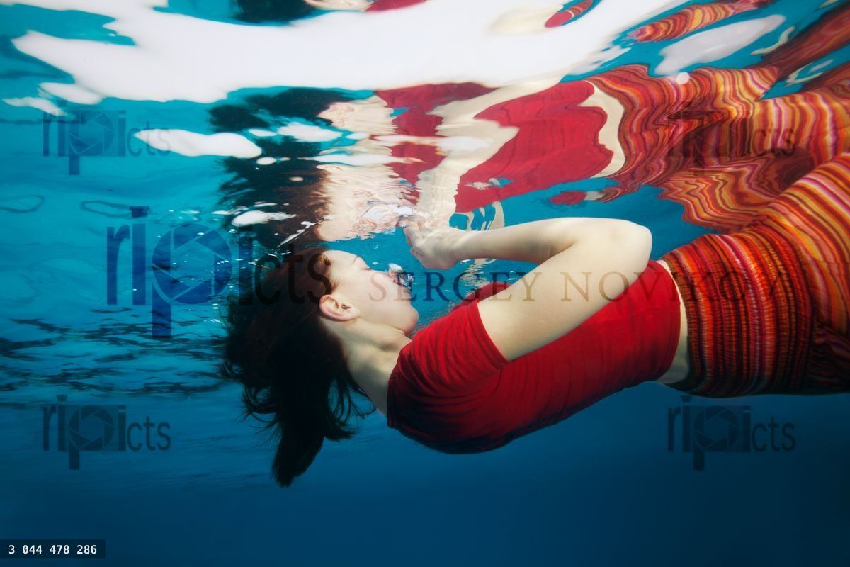Woman underwater with reflection from surface
