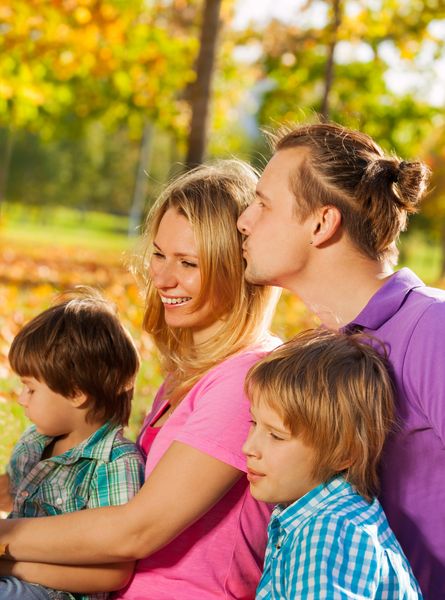Close up of happy family sitting together in hug