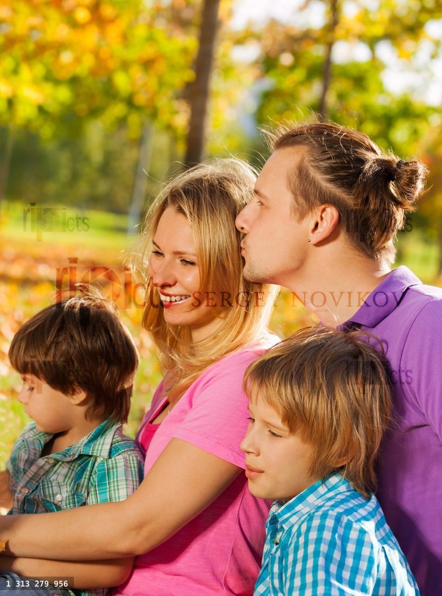 Close up of happy family sitting together in hug