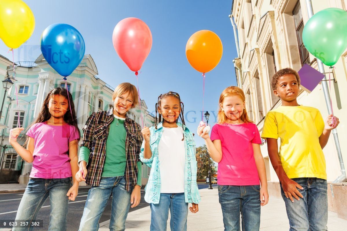 Multinational children with balloons standing