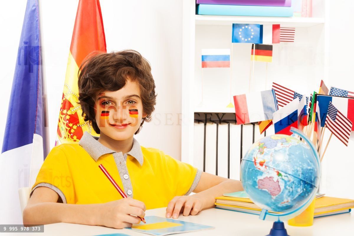 German schoolboy writing at copybook in classroom