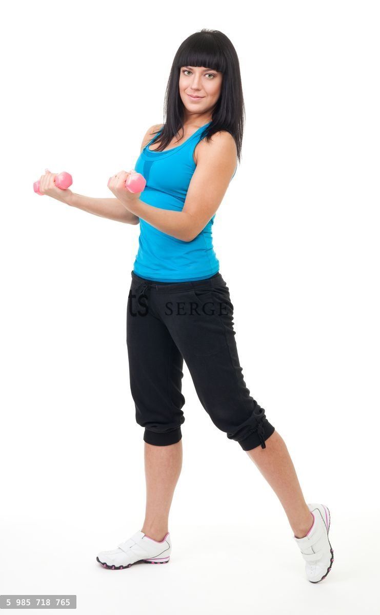 Young woman do fitness using dumbbells