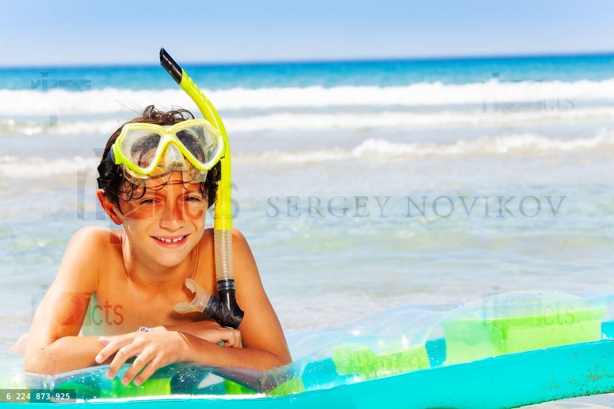 Young diver enjoying summer vacation on the beach
