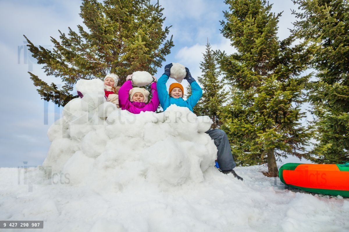 Group of happy kids play snowballs game together