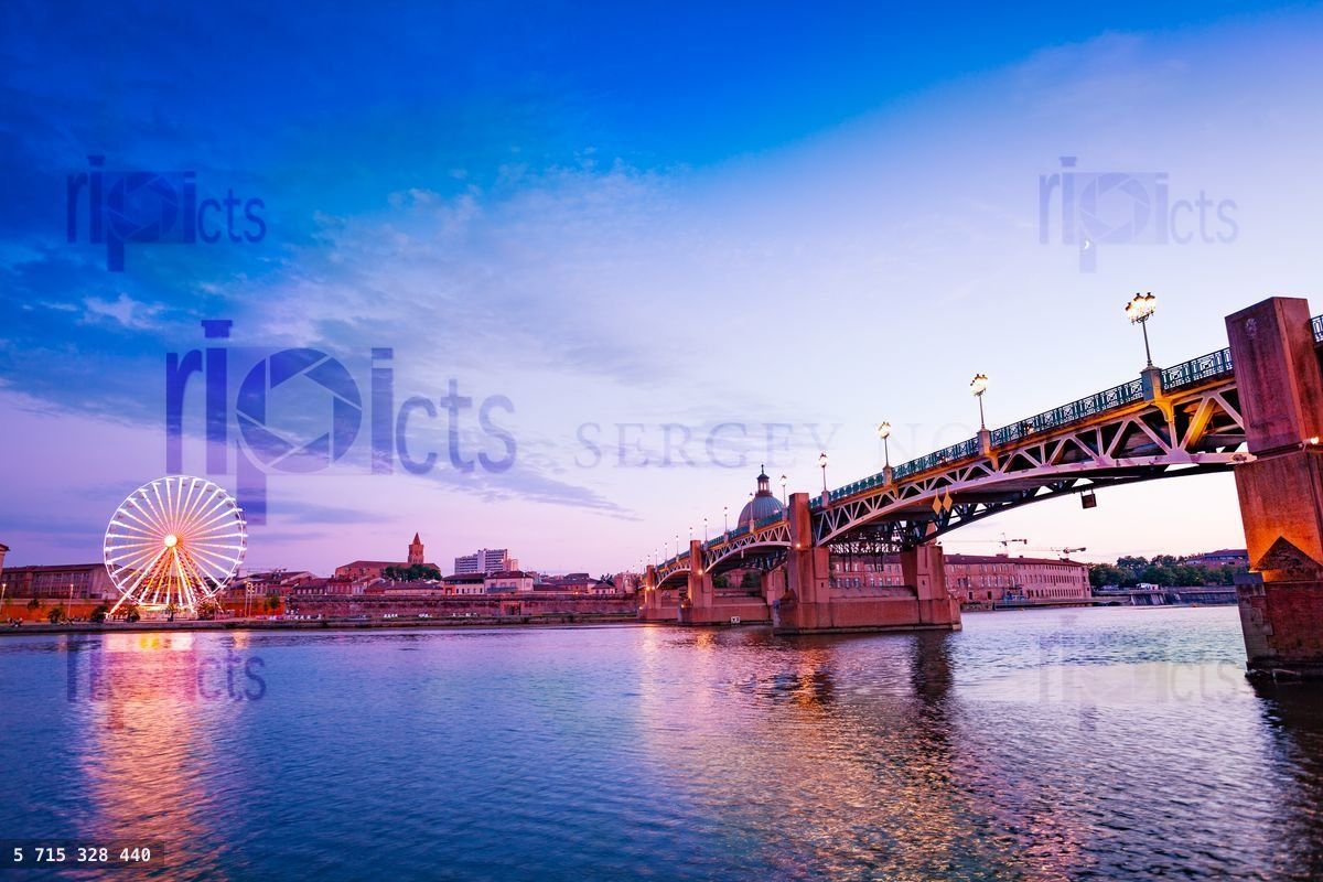 Garonne riverside with ferris wheel at sunset