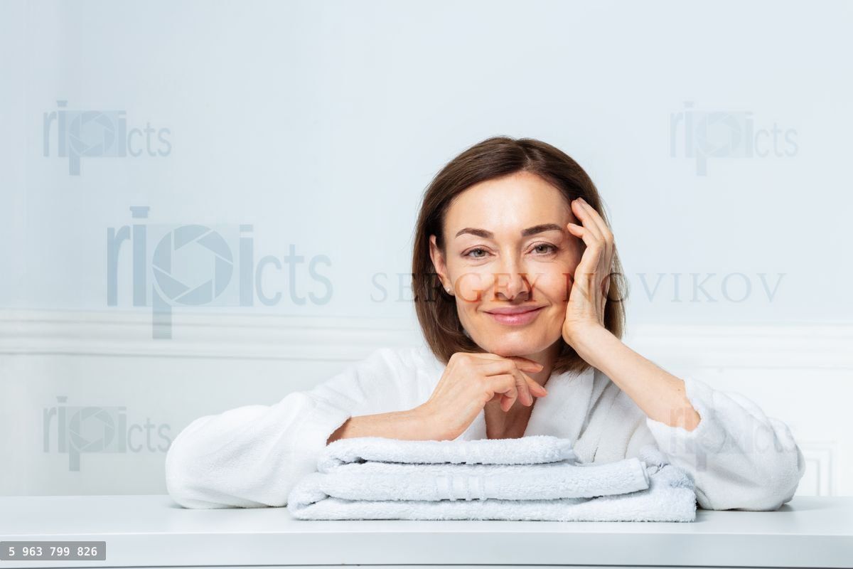 Woman's beauty portrait, confidently smiling in bathrobe