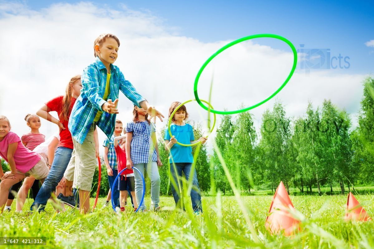 Children playing and throwing colorful hoops