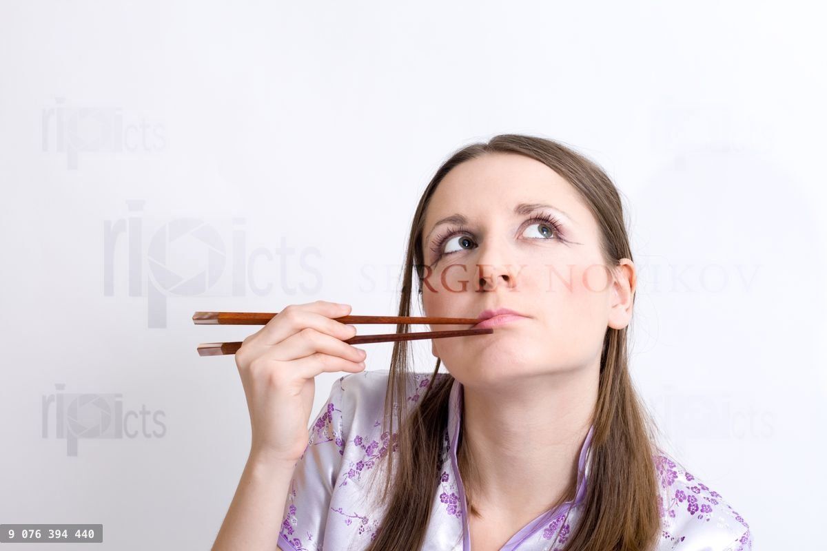 Woman with chopsticks for sushi