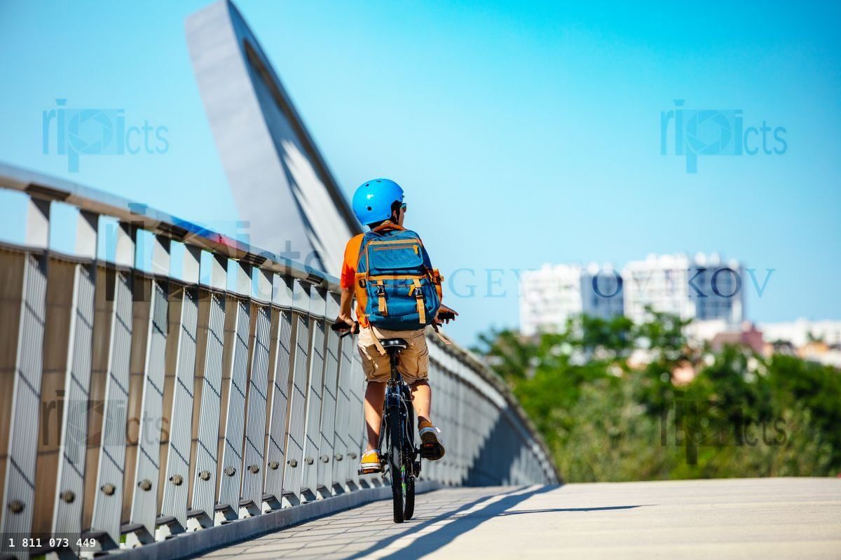 Confident boy cycle to school on bike in city