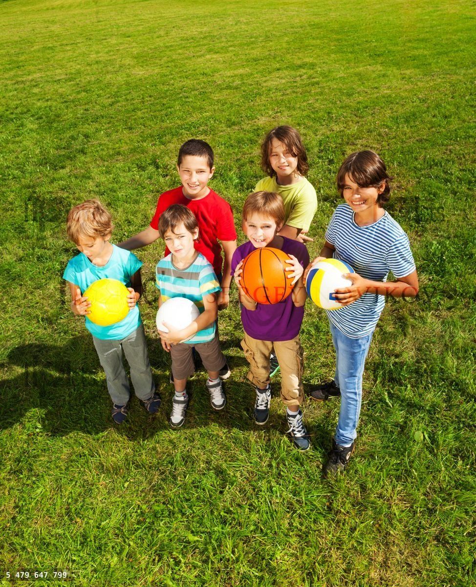 Boys with balls in the grass