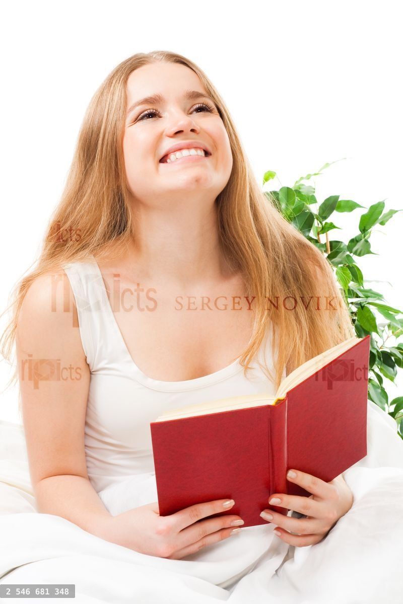 Woman read book sitting in bed