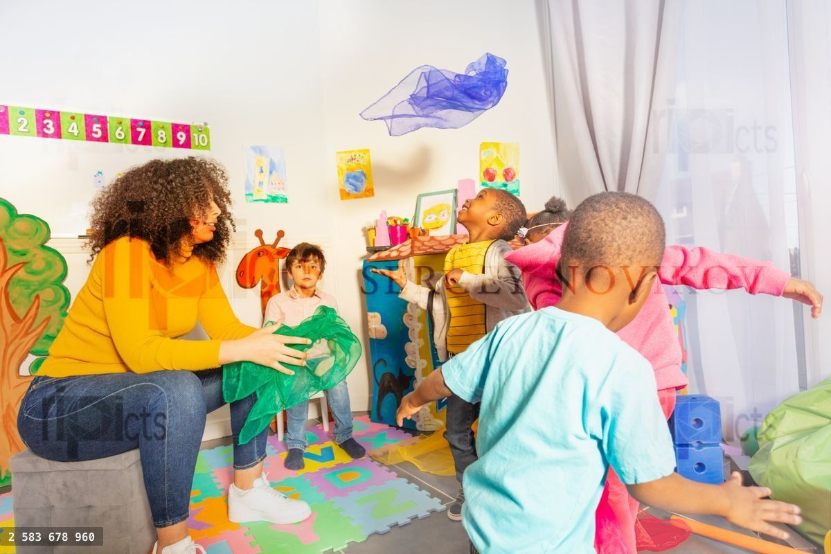 Fun active game with little kids throwing fabric