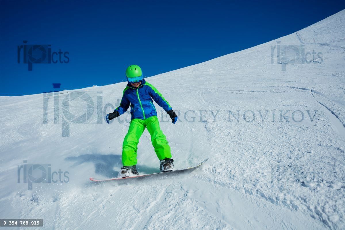Action photo of boy snowboard down mountain slope fast
