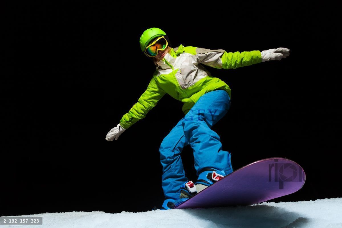 Woman balancing with hands on snowboard