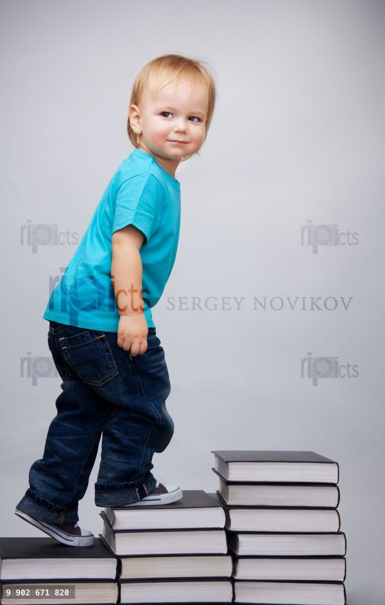 Young man climbing on a ladder of books