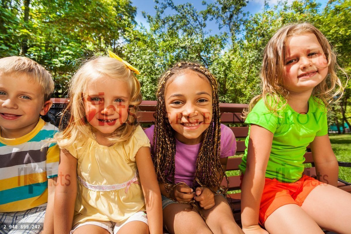Four kids on the bench in park