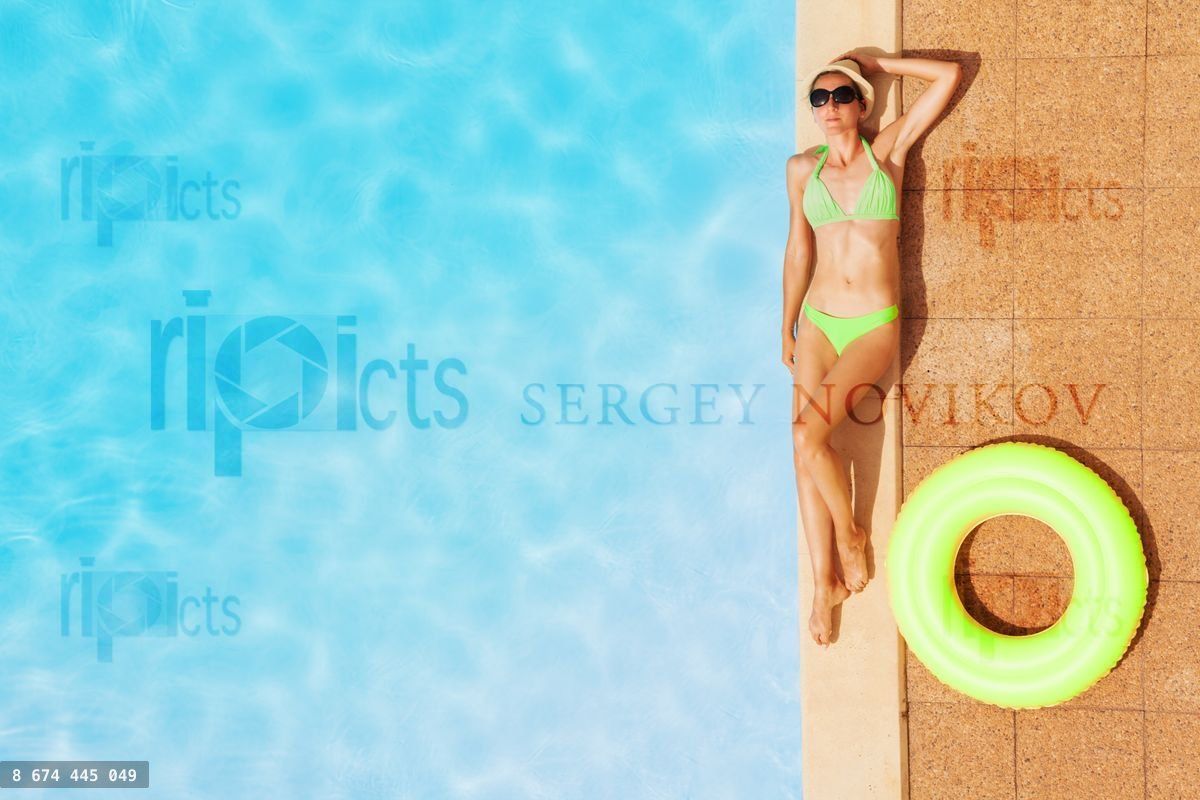 Young woman in swimsuit relaxing by swimming pool
